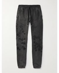 Amiri - Pigment Spray Star Tapered Leather-trimmed Cotton-jersey Sweatpants - Lyst