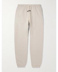 Fear of God ESSENTIALS - Tapered Logo-appliquéd Cotton-blend Jersey Sweatpants - Lyst