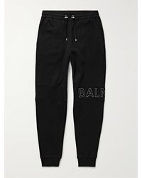 Balmain - Slim-fit Tapered Reflective Logo-embossed Cotton-jersey Sweatpants - Lyst