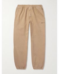 Givenchy - Schmal zulaufende Hose aus Twill aus einer Baumwollmischung mit Jacquard-Logomuster und Applikation - Lyst