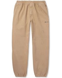 Givenchy - Tapered Appliquéd Logo-Jacquard Cotton-Blend Twill Trousers - Lyst