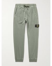 Stone Island - Tapered Logo-Appliquéd Garment-Dyed Cotton-Jersey Sweatpants - Lyst