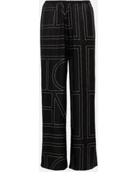 Totême - Pantalones anchos de seda con logo - Lyst