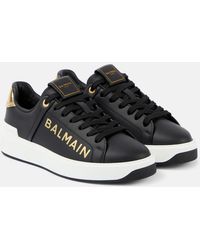 Balmain - Sneakers in pelle di vitello nero/oro - Lyst