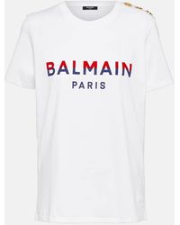Balmain - T-shirt con stampa logo bicolore e bottoni logati in cotone - Lyst