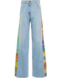 Femme Vêtements Jeans Jeans à pattes d’éléphant Wide leg jeans Jean Versace en coloris Bleu 