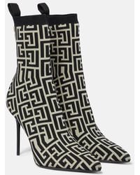 Balmain - Skye stretch knit ankle boots with monogram - Lyst