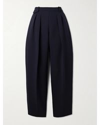 KHAITE - Dugan Pleated Crepe Tapered Pants - Lyst