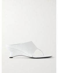KHAITE - Marlow Leather Wedge Mules - Lyst