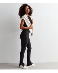 New Look - Ribbed Split Hem Flared Leggings - Lyst