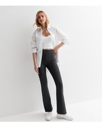 New Look - Dark Ribbed Jersey Flared Trousers - Lyst