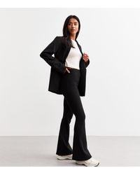 New Look - Petite Ribbed Flared Trousers - Lyst