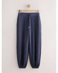 Next - Active Modal Balloon Leg Trousers - Lyst