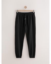 Next - Cuffed Regular Fit Brushback Joggers - Lyst
