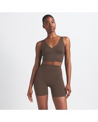 Nike - Skims Matte V-Neck Long-Line Bra - Lyst