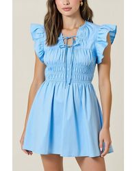 Modenaire - Smocked Mini Dress With Ruffle Sleeves And Front Tie Detail - Lyst