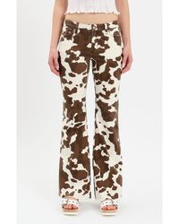 DAZE - Lowkey Cow Print Flare Jeans - Lyst