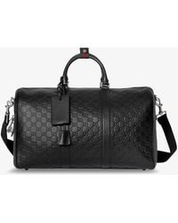 Gucci - Coated Canvas Gg Emblem Travel Bag With Gg Motif - Lyst