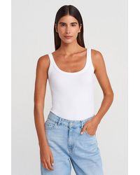 Dilvin - Sleeveless Ribbed Cotton-Blend Bodysuit - Lyst