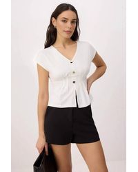 WOVCOR - Button Detail V Neck Cap Sleeve Peplum Top - Lyst