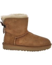 UGG Mini Bailey Button Booties in Sand (Natural) | Lyst