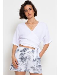SassyClassy - Musselin Bluse mit Bindeband und lockerer Passform Kurzarm Wickelbluse aus Baumwolle - Lyst