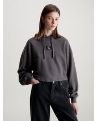 Calvin Klein - Kapuzensweatshirt WASHED WOVEN LABEL HOODIE mit Logoschriftzug - Lyst