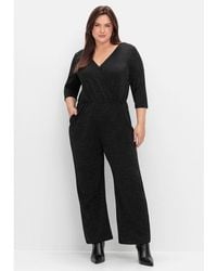 Sheego - Jumpsuit Große Größen in Wickeloptik, mit Glitzergarn - Lyst