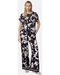 Comma, - Stoffhose Feminine Schlupfhose mit weitem Bein und All-over-Print - Lyst