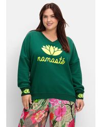 Sheego - Sweatshirt Große Größen mit Yogaprint vorn und an den Bündchen - Lyst