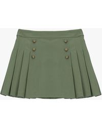 Please - Jupe Courte À Plis Et Boutons Décoratifs - Lyst