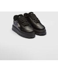 Prada - Leather And Shearling Sneakers - Lyst