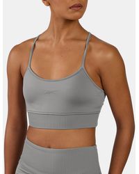 Reebok - Lux Peached Strappy Sports Bra - Lyst