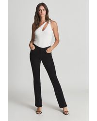 PAIGE - Black Lou Lou High Rise Twisted Seam Flared Jeans - Lyst