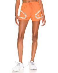 Damen Bekleidung Kurze Hosen Knielange Shorts und lange Shorts adidas By Stella McCartney Radlerhose asmc True Pace Running in Orange 