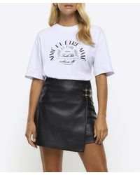 River Island - Black Faux Leather Buckle Wrap Mini Skirt - Lyst