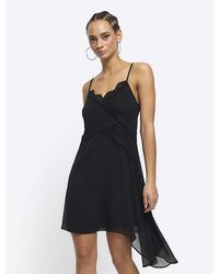 River Island - Black Lace Trim Asymmetric Slip Mini Dress - Lyst