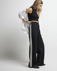 River Island - Black Side Stripe Wide Leg Joggers - Lyst