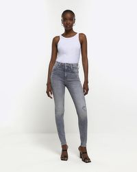 River Island - Ripped High Waisted Super Skinny Jeans - Lyst