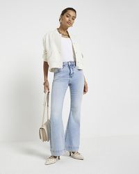 River Island - Petite Blue High Waisted Flared Jeans - Lyst