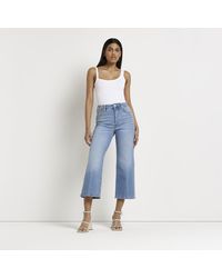 River Island - Blue Mid Rise Cropped Flared Jeans - Lyst