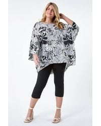 Roman Curve - Floral Print Dipped Hem Top - Lyst