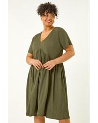 Roman Curve - Textured V-Neck Stretch Dress - Lyst