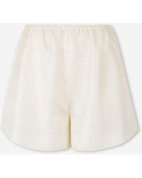 TOTEME - Shorts Anchos Monograma - Lyst