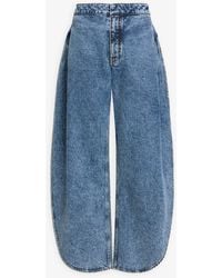 Alaïa - Side-Split Petal Round Jeans - Lyst
