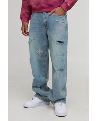 BoohooMAN - Relaxed Fit Rhinestone Cross Ripped Jeans - Lyst