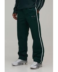 BoohooMAN - Relaxed Fit Side Stripe Logo Print Nylon Trousers - Lyst
