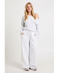 Boohoo - Petite Cinched Waist Off Shoulder Straight Leg Tracksuit - Lyst