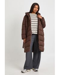 Boohoo - Plus Belted Longline Puffer Jacket - Lyst