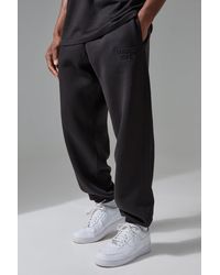 BoohooMAN - Active Training Dept Oversized Embossed Sweatpants - Lyst